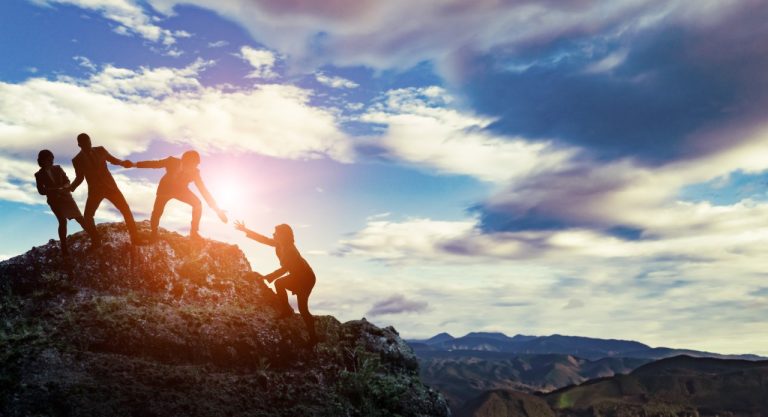 image of person being offered support by friends while climbing mountain, after she got online counseling for depression with Foram Zaveri, learn how to handle depression with online therapy